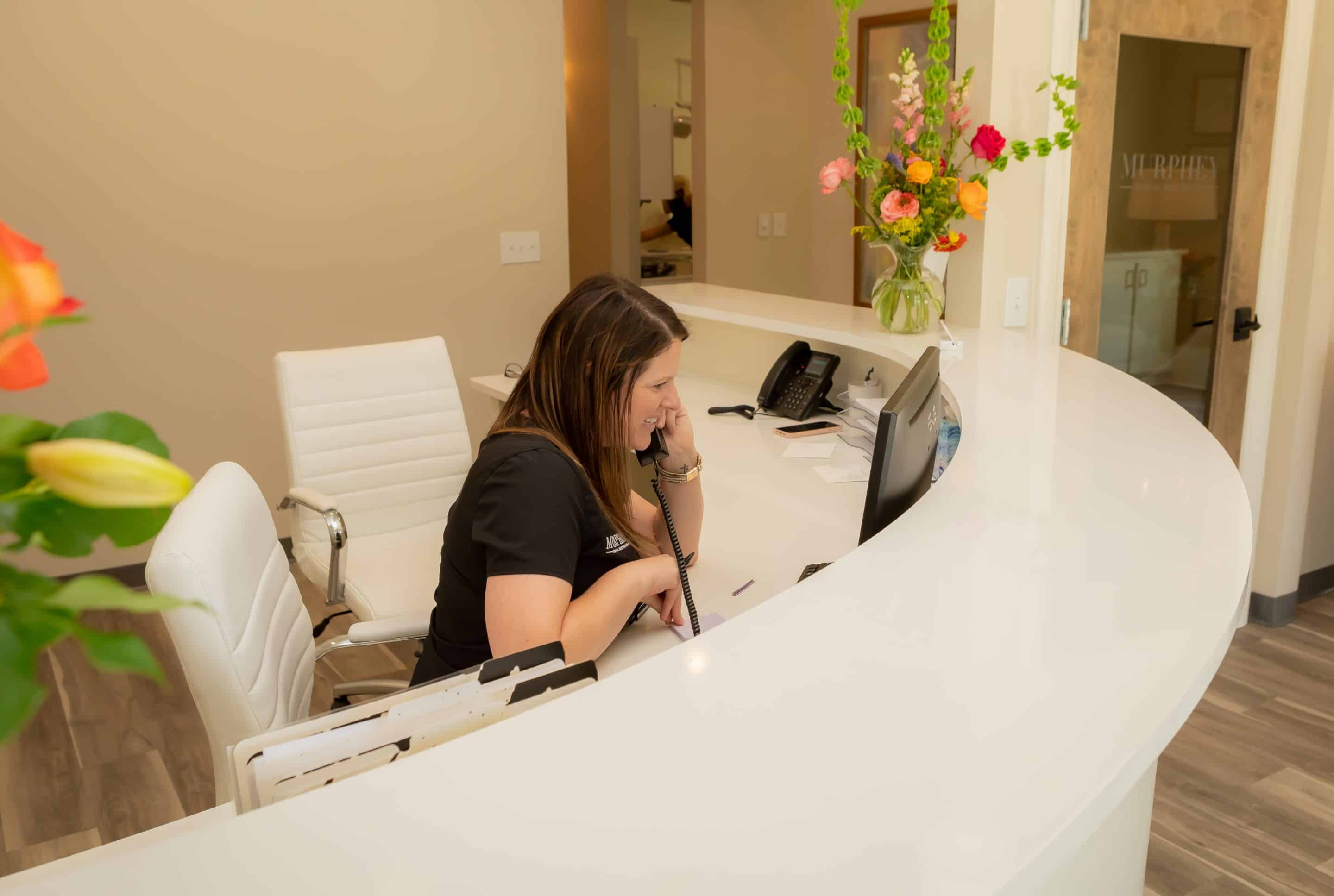 receptionist scheduling a dental implant appointment at Murphey Dental Aesthetics  in ridgeland ms