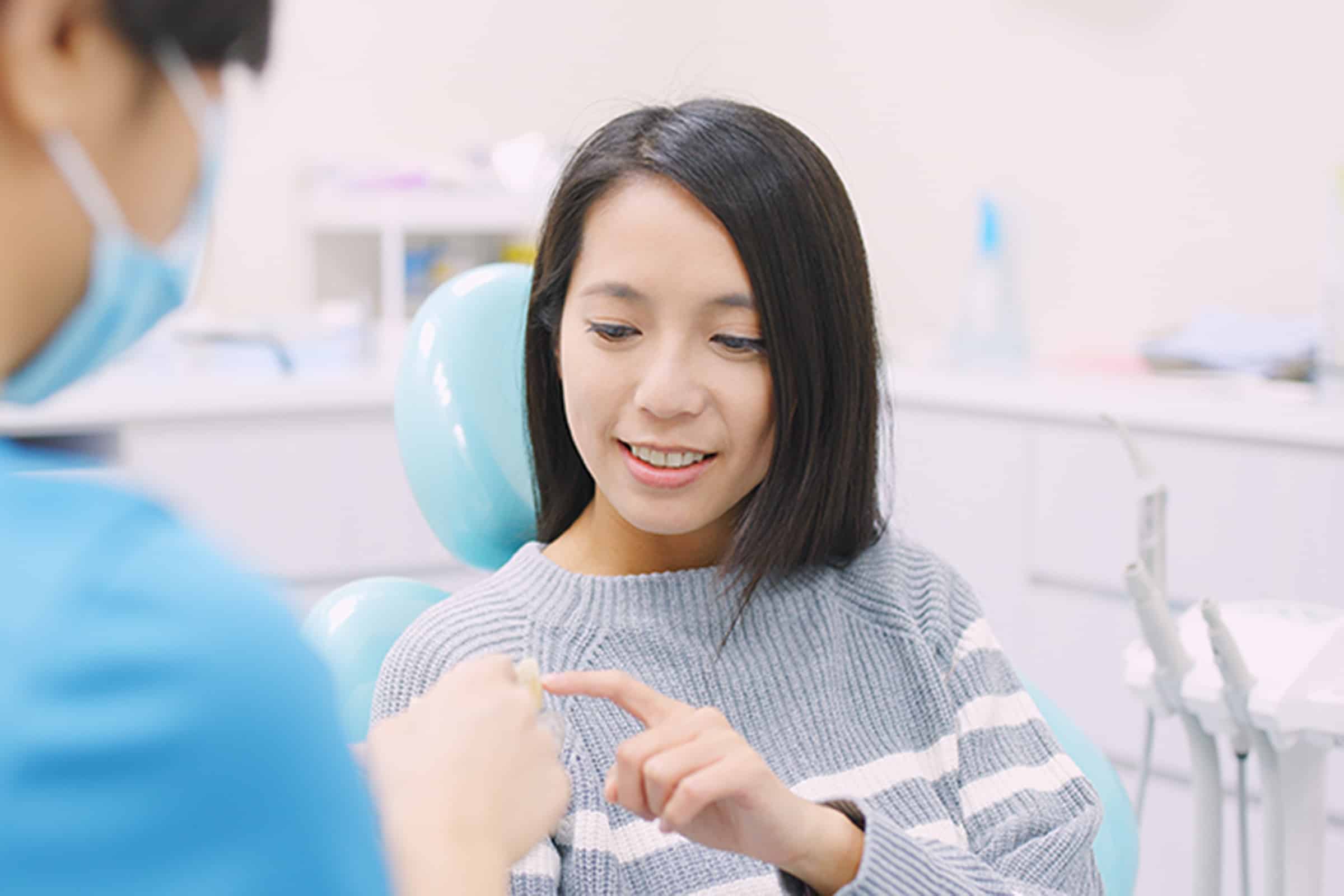 Woman getting a dental implant restoration consultation in Ridgeland, MS